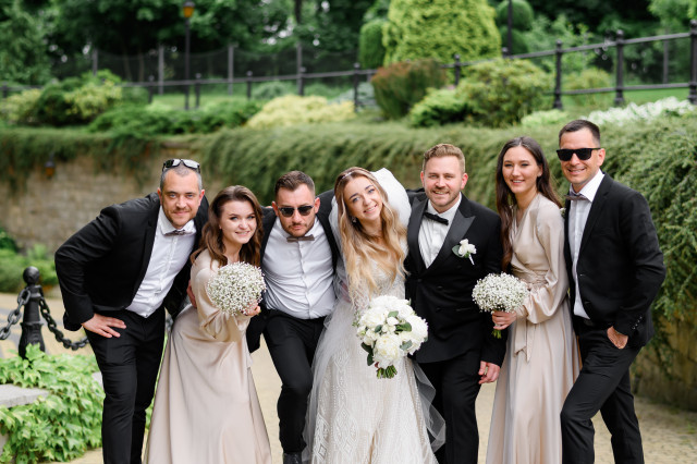 front-view-stylish-friends-newlyweds-festival-outfits-hugging-each-other-smiling-posing-camera-wedding-walking-park-background